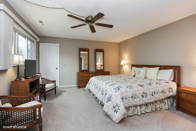 108 Ginger Court Rolling Meadows, IL 60008 - Photo 8 of 15 a bedroom with a bed a couch and a dresser