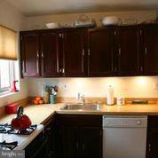 3900 Tunlaw Road Northwest, Unit 610 Washington, DC 20007 - Photo 2 of 22 a kitchen with a sink and cabinets