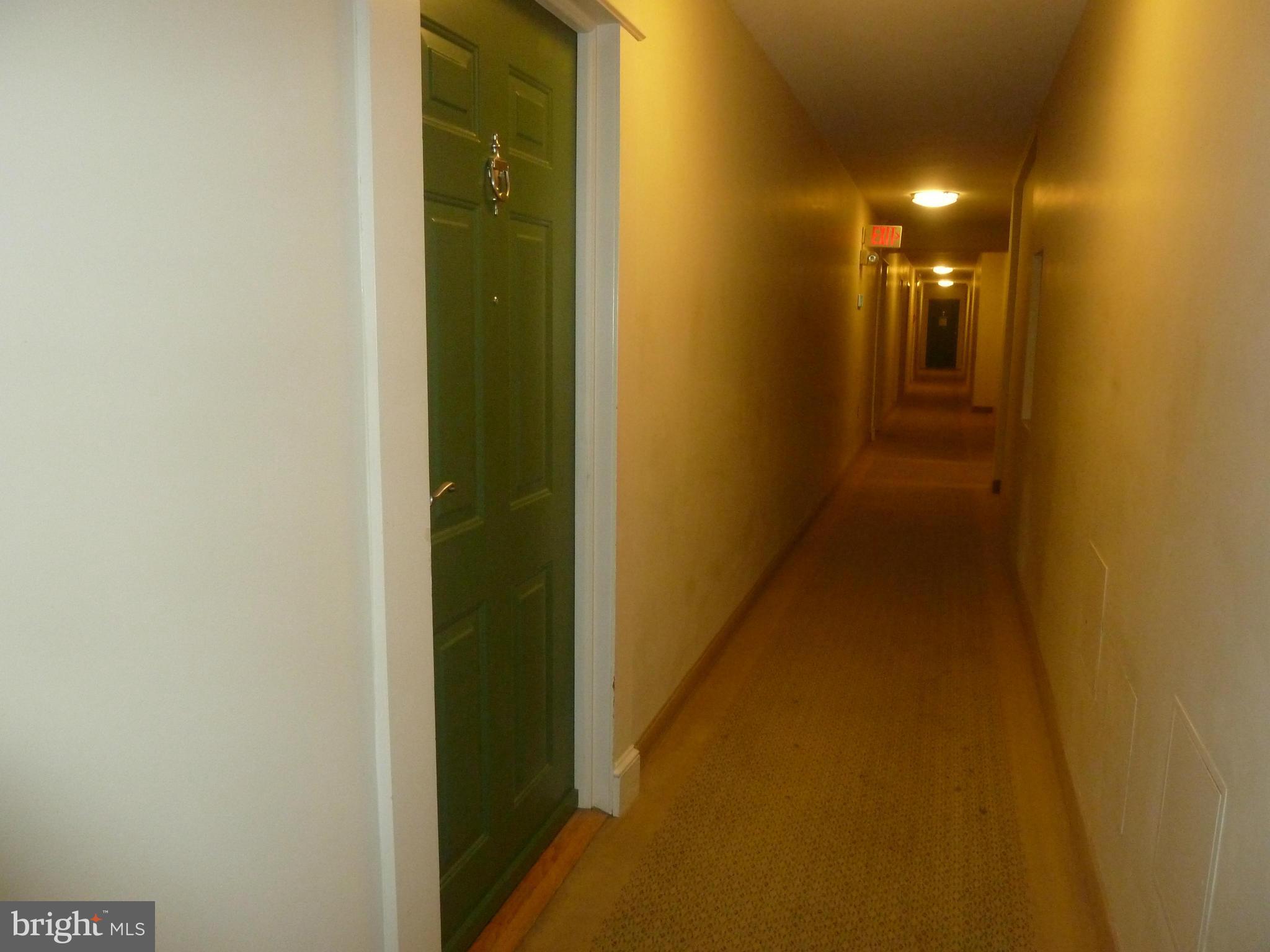 3900 Tunlaw Road Northwest, Unit 610 Washington, DC 20007 - Photo 15 of 22 a view of a hallway with wooden floor