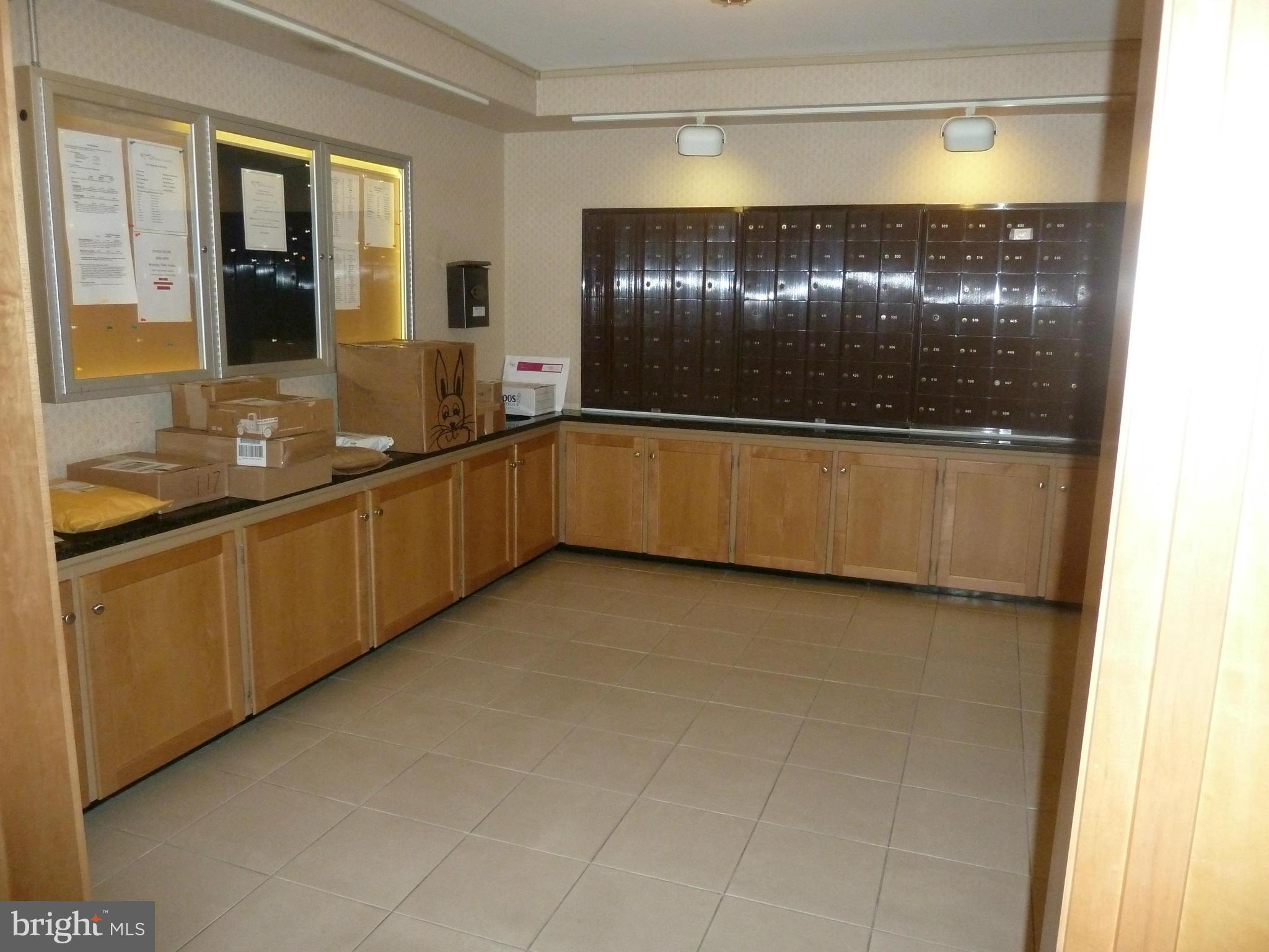 3900 Tunlaw Road Northwest, Unit 610 Washington, DC 20007 - Photo 17 of 22 a large white kitchen with a sink and dishwasher