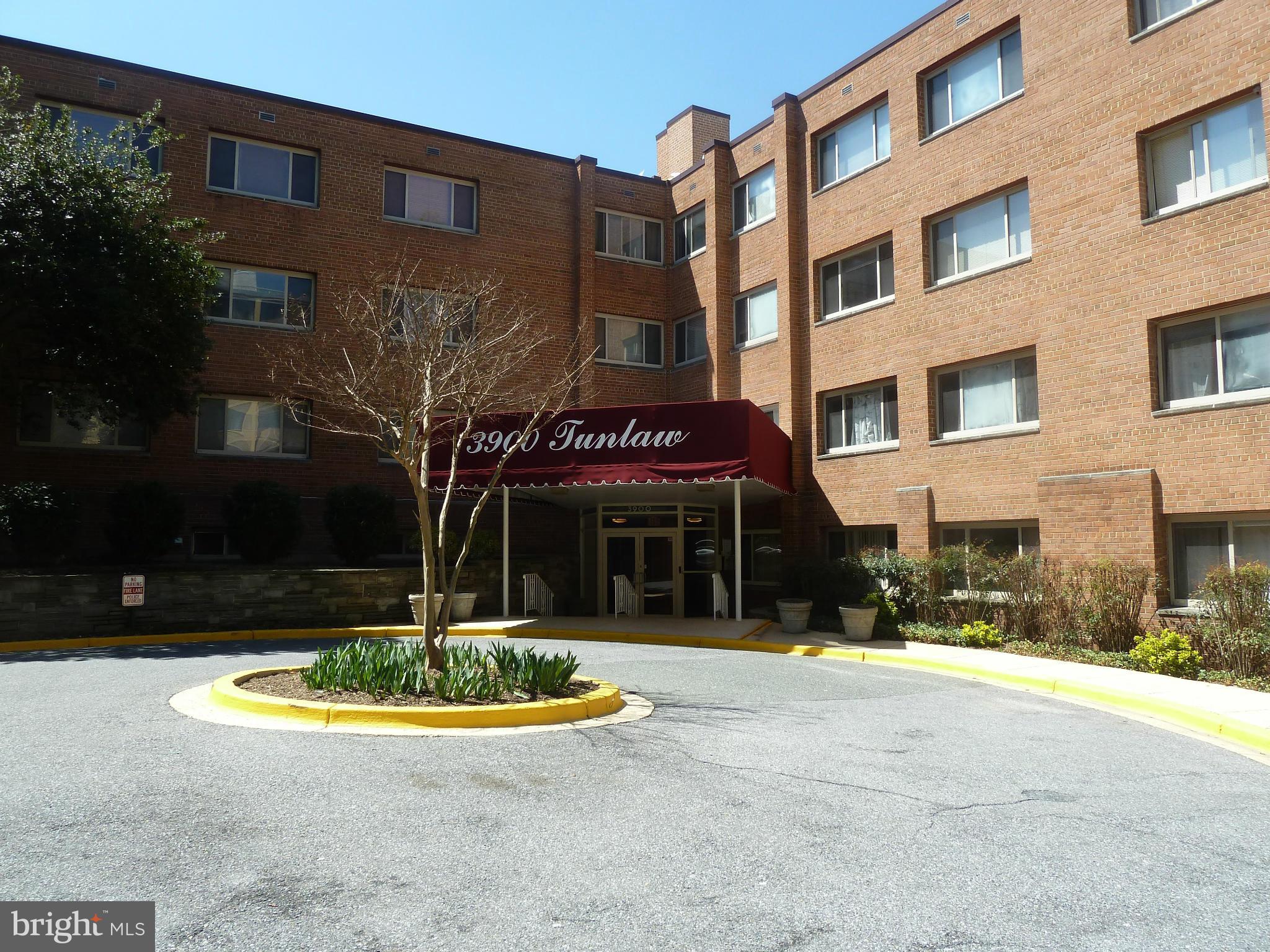 3900 Tunlaw Road Northwest, Unit 610 Washington, DC 20007 - Photo 20 of 22 a view of a building with a yard