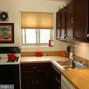 3900 Tunlaw Road Northwest, Unit 610 Washington, DC 20007 - Photo 3 of 22 a kitchen with a sink cabinets and window