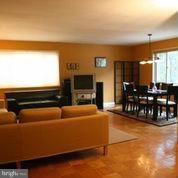 3900 Tunlaw Road Northwest, Unit 610 Washington, DC 20007 - Photo 6 of 22 a living room with furniture and a flat screen tv