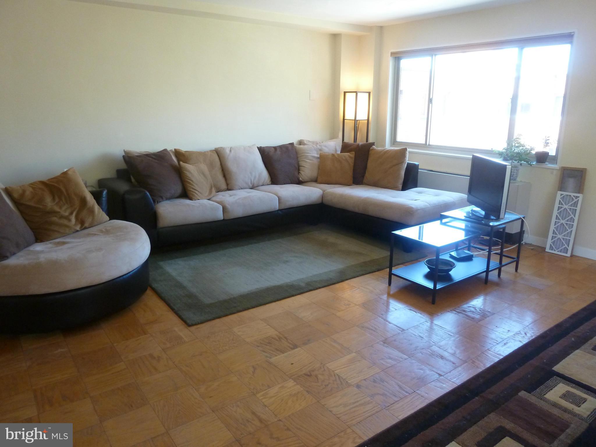 3900 Tunlaw Road Northwest, Unit 610 Washington, DC 20007 - Photo 7 of 22 a living room with furniture and a couch