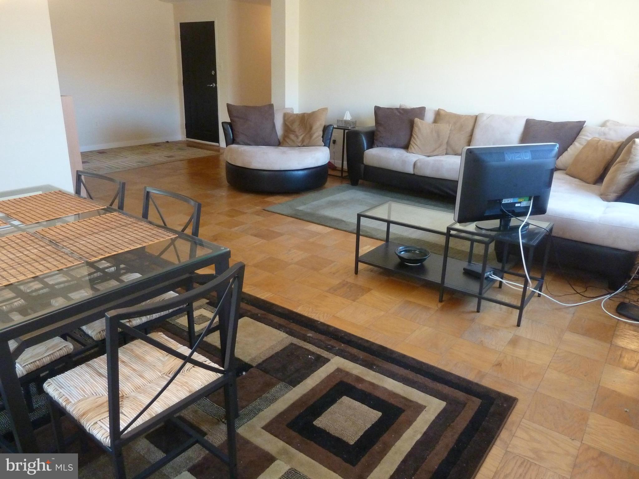 3900 Tunlaw Road Northwest, Unit 610 Washington, DC 20007 - Photo 8 of 22 a living room with furniture and a rug