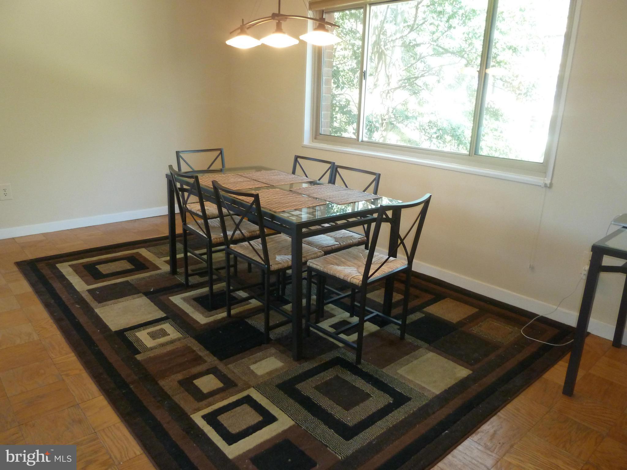 3900 Tunlaw Road Northwest, Unit 610 Washington, DC 20007 - Photo 9 of 22 a view of a dining room with a table and chairs