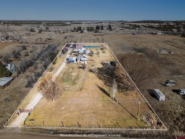 a view of house with wooden deck and furniture