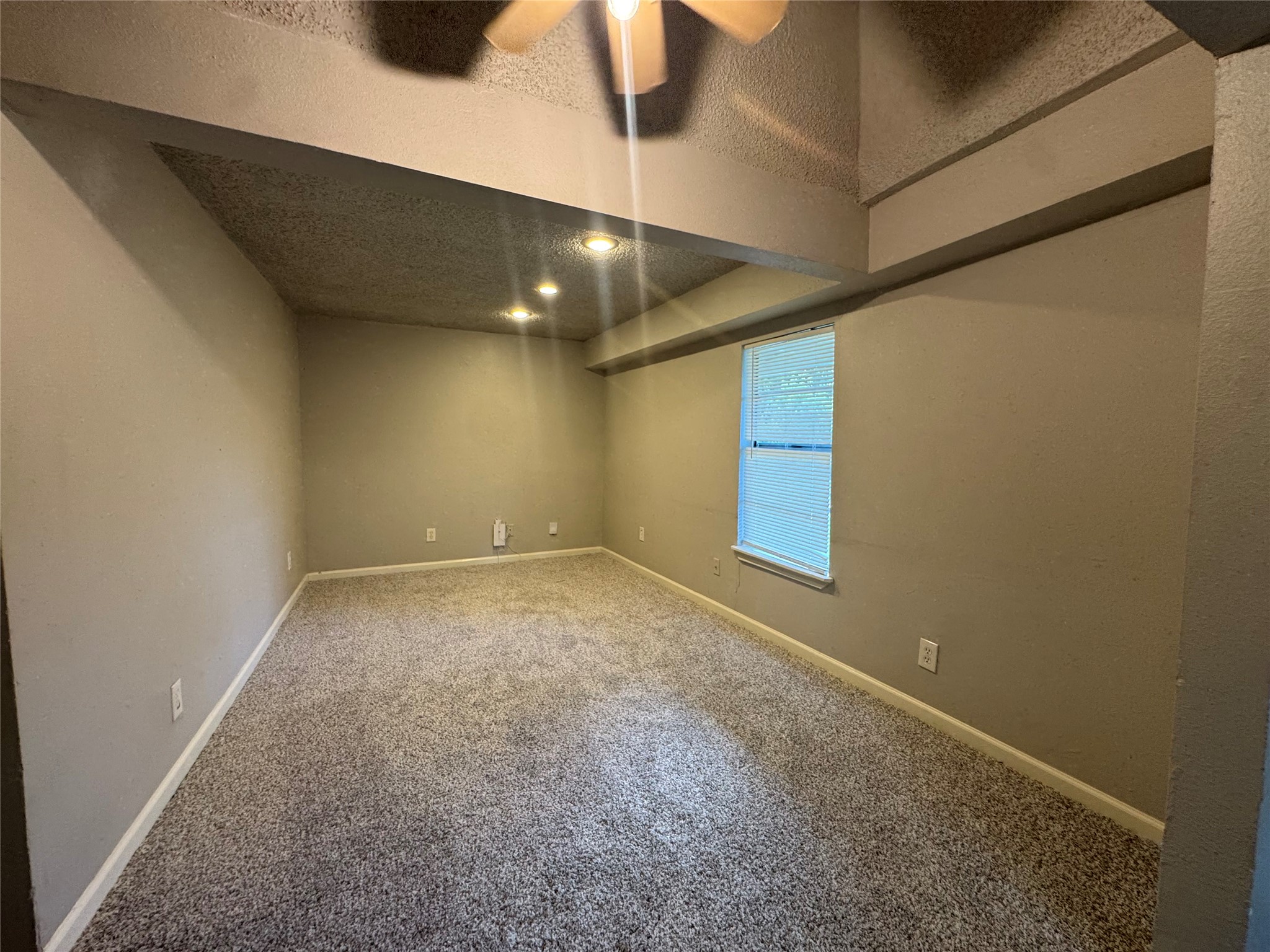 5007 Heflin Lane Austin, TX 78721 - Photo 5 of 25 Well-lit room with plush carpeting and natural light from a window.
