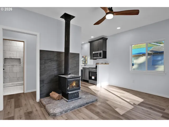 a kitchen with stainless steel appliances a stove a microwave a sink and cabinets