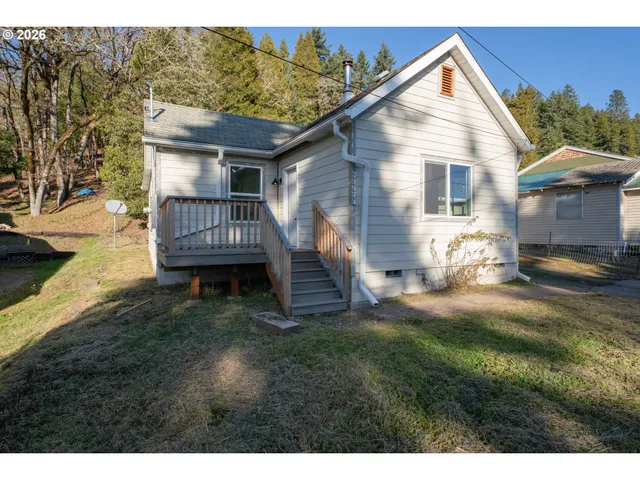 a view of house with backyard and outdoor seating