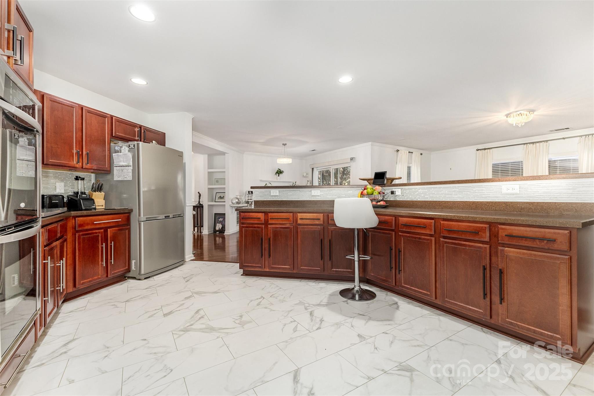 6706 Evanton Loch Road Charlotte, NC 28278 - Photo 11 of 32 a kitchen with stainless steel appliances granite countertop a refrigerator sink and cabinets