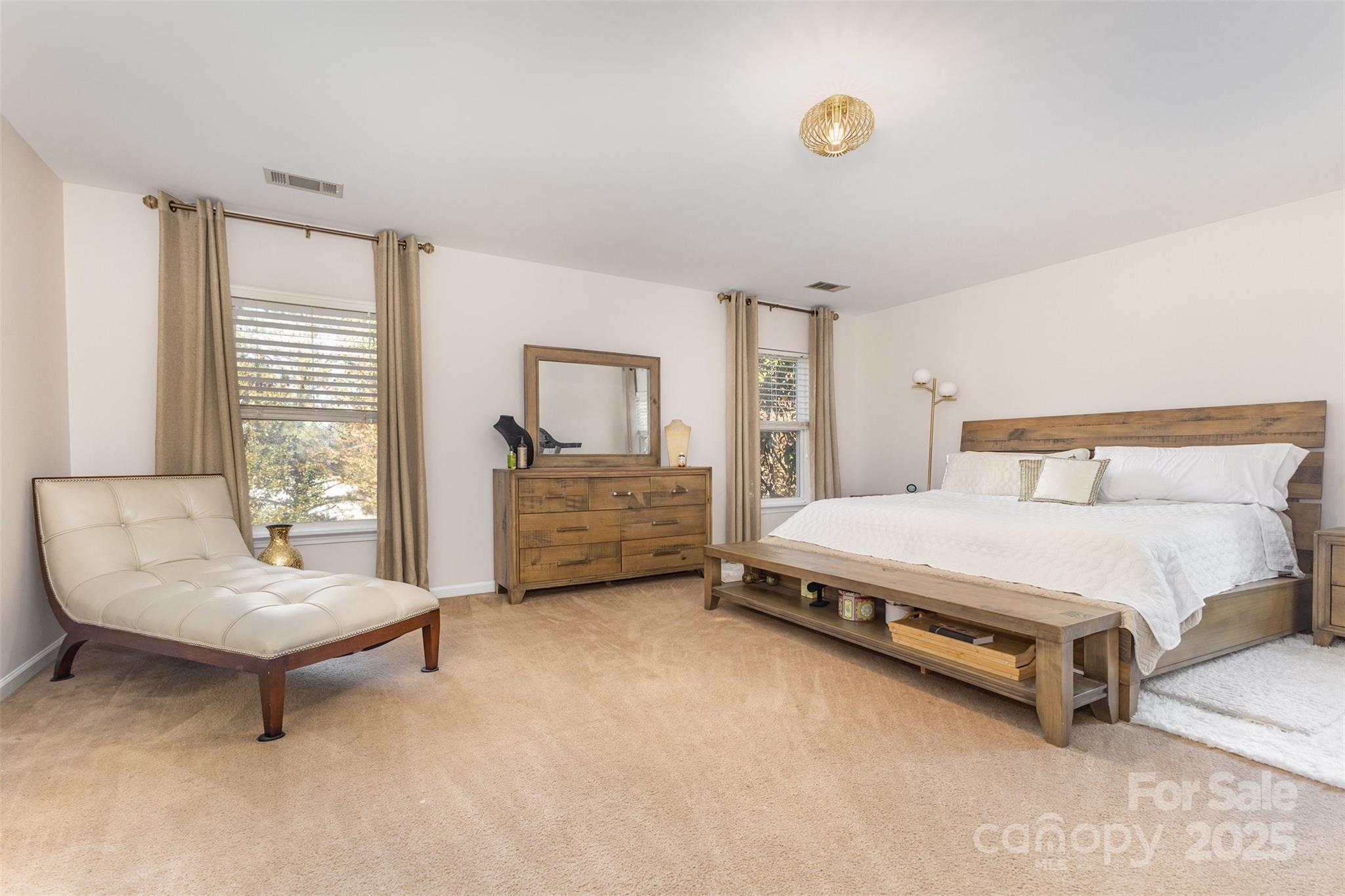 6706 Evanton Loch Road Charlotte, NC 28278 - Photo 20 of 32 a spacious bedroom with a bed and a window