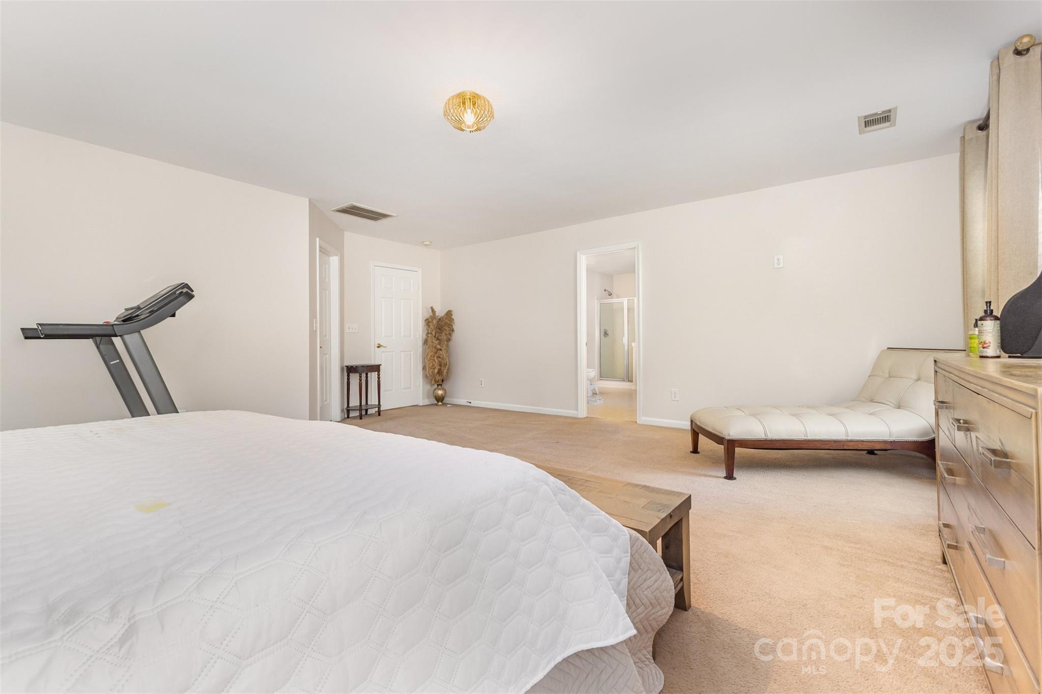 6706 Evanton Loch Road Charlotte, NC 28278 - Photo 21 of 32 a bedroom with a bed and a chair