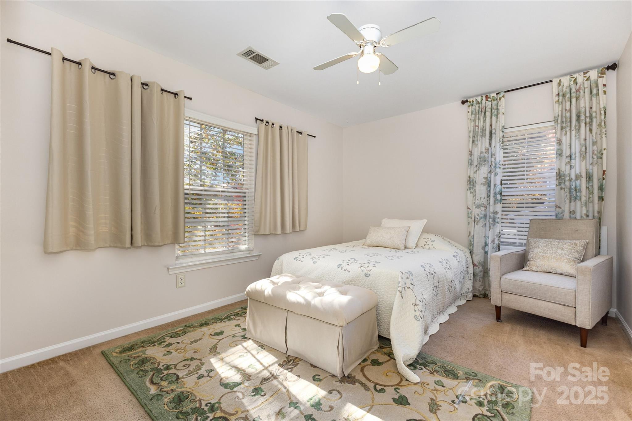 6706 Evanton Loch Road Charlotte, NC 28278 - Photo 24 of 32 a spacious bedroom with a bed and a couch
