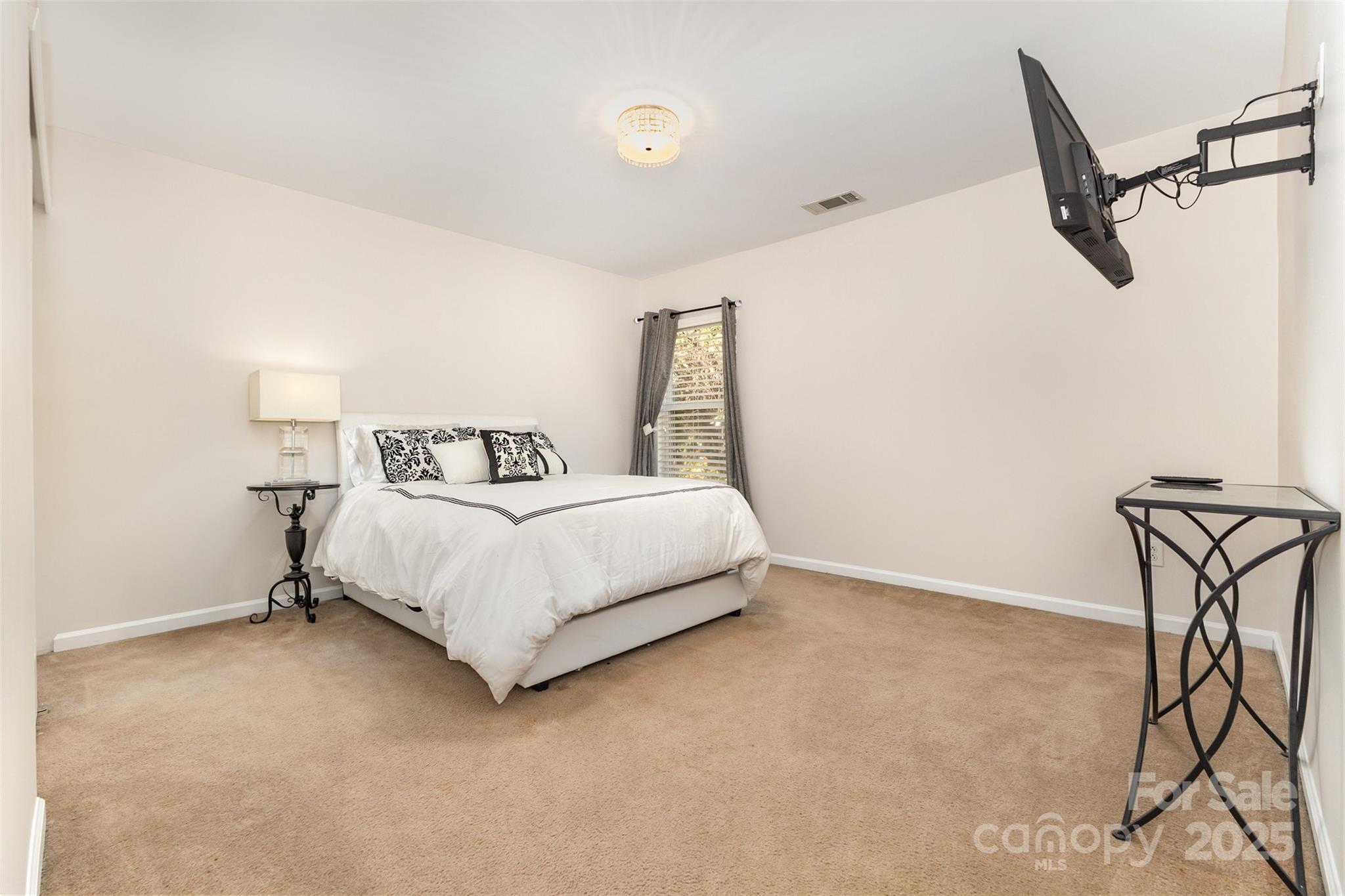 6706 Evanton Loch Road Charlotte, NC 28278 - Photo 26 of 32 a bedroom with a bed and a table