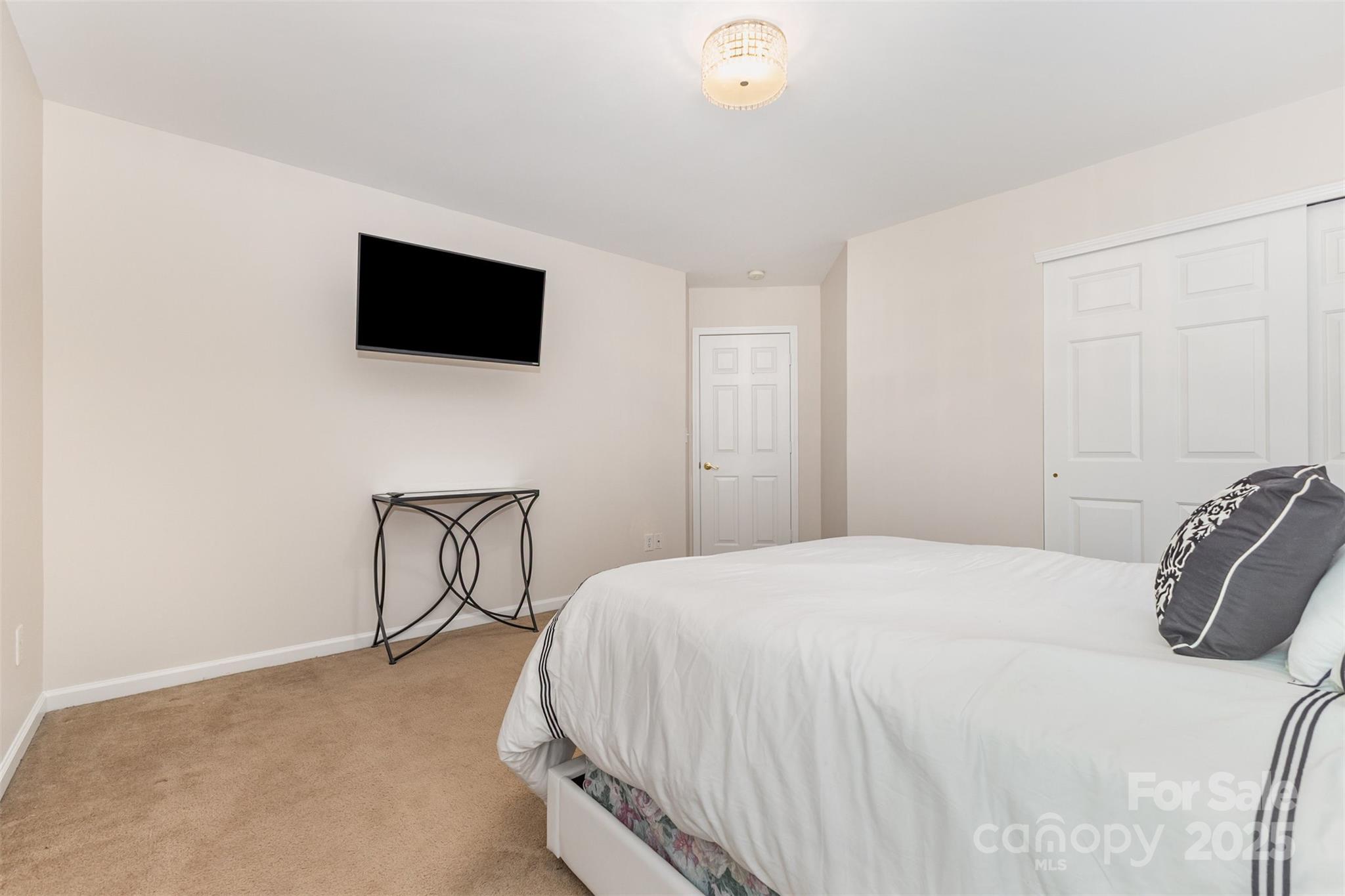 6706 Evanton Loch Road Charlotte, NC 28278 - Photo 27 of 32 a bedroom with a bed and a flat screen tv