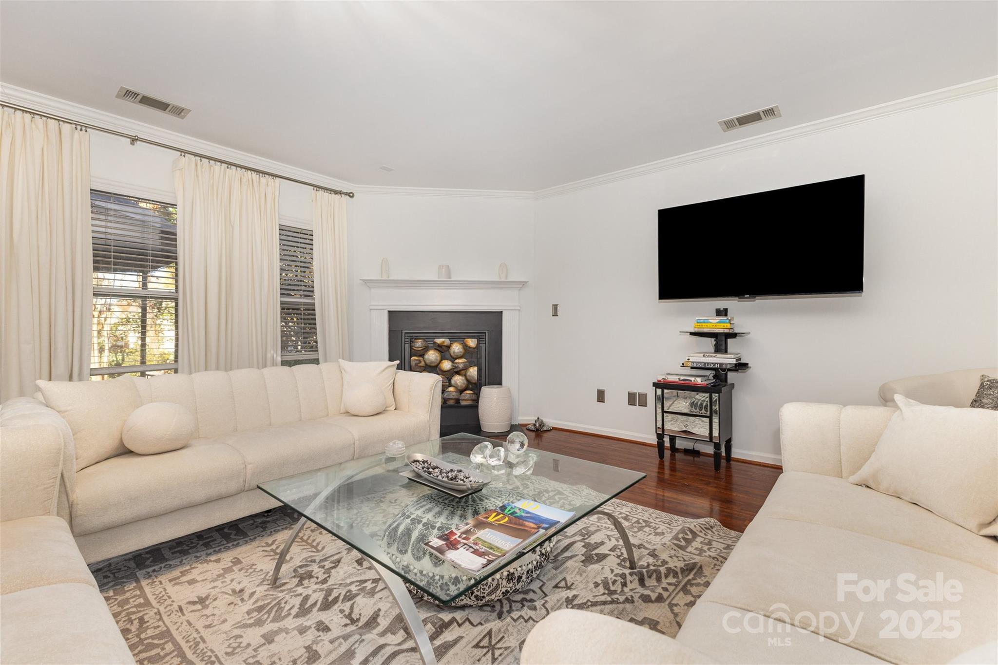 6706 Evanton Loch Road Charlotte, NC 28278 - Photo 8 of 32 a living room with furniture a flat screen tv and a large window