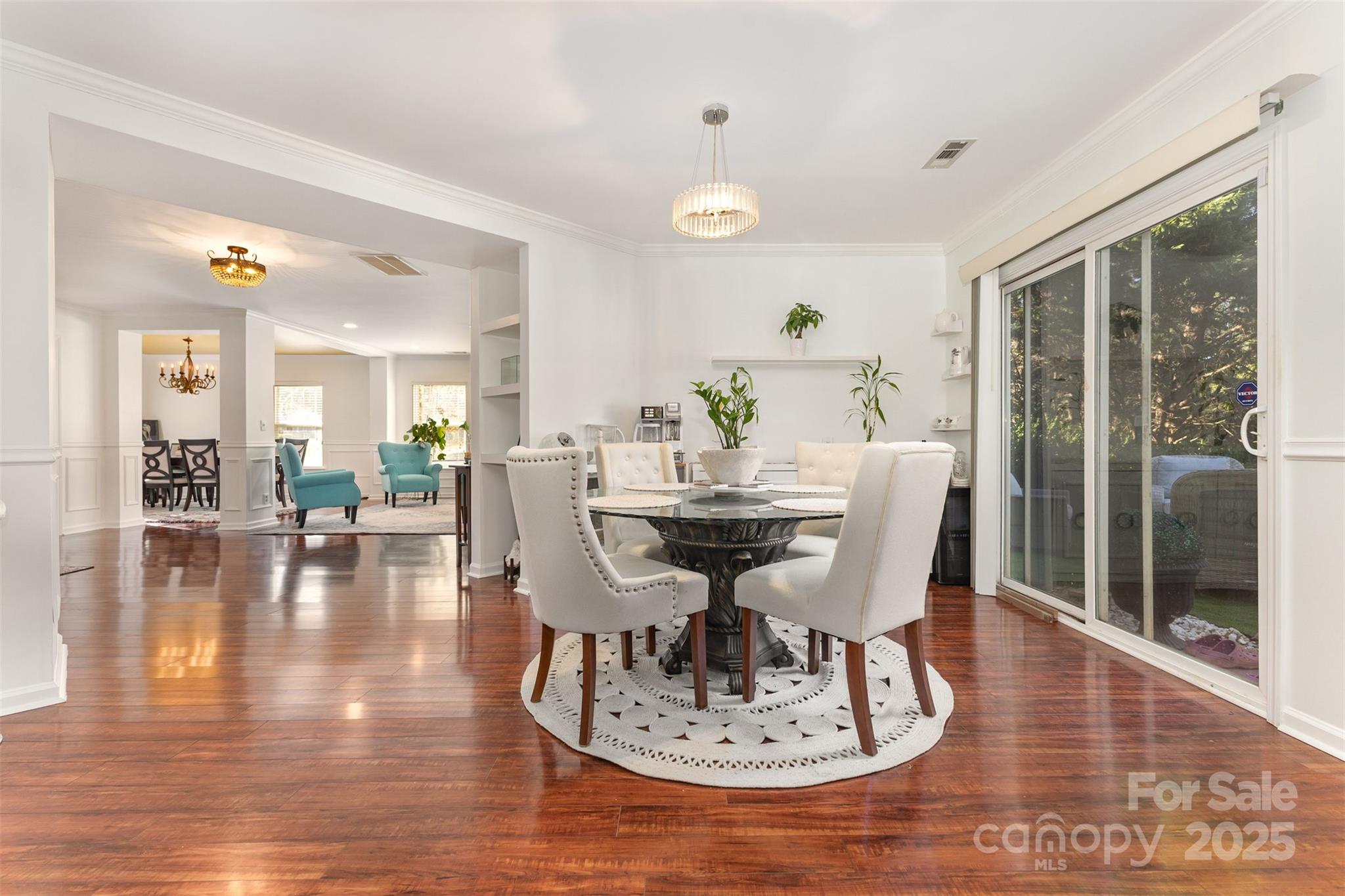 6706 Evanton Loch Road Charlotte, NC 28278 - Photo 10 of 32 a view of a dining room with furniture and wooden floor