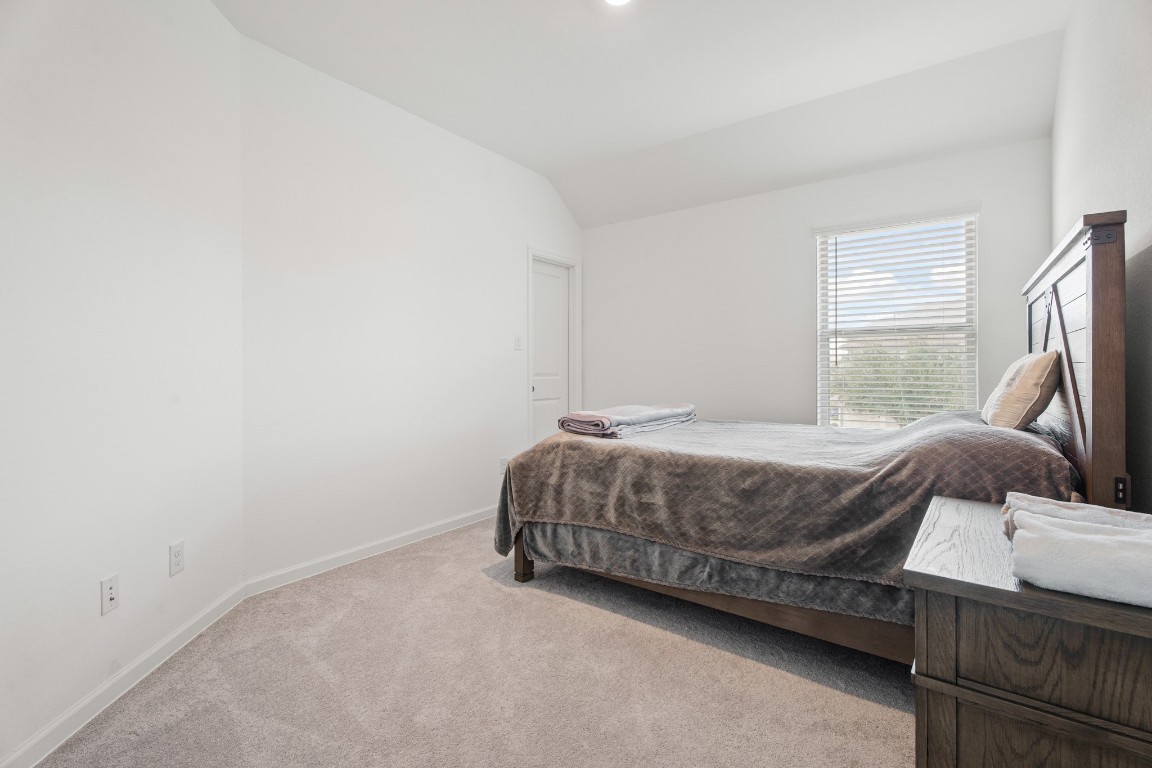 4103 Balboa Drive Iowa Colony, TX 77583 - Photo 21 of 30 a bedroom with a bed and a couch