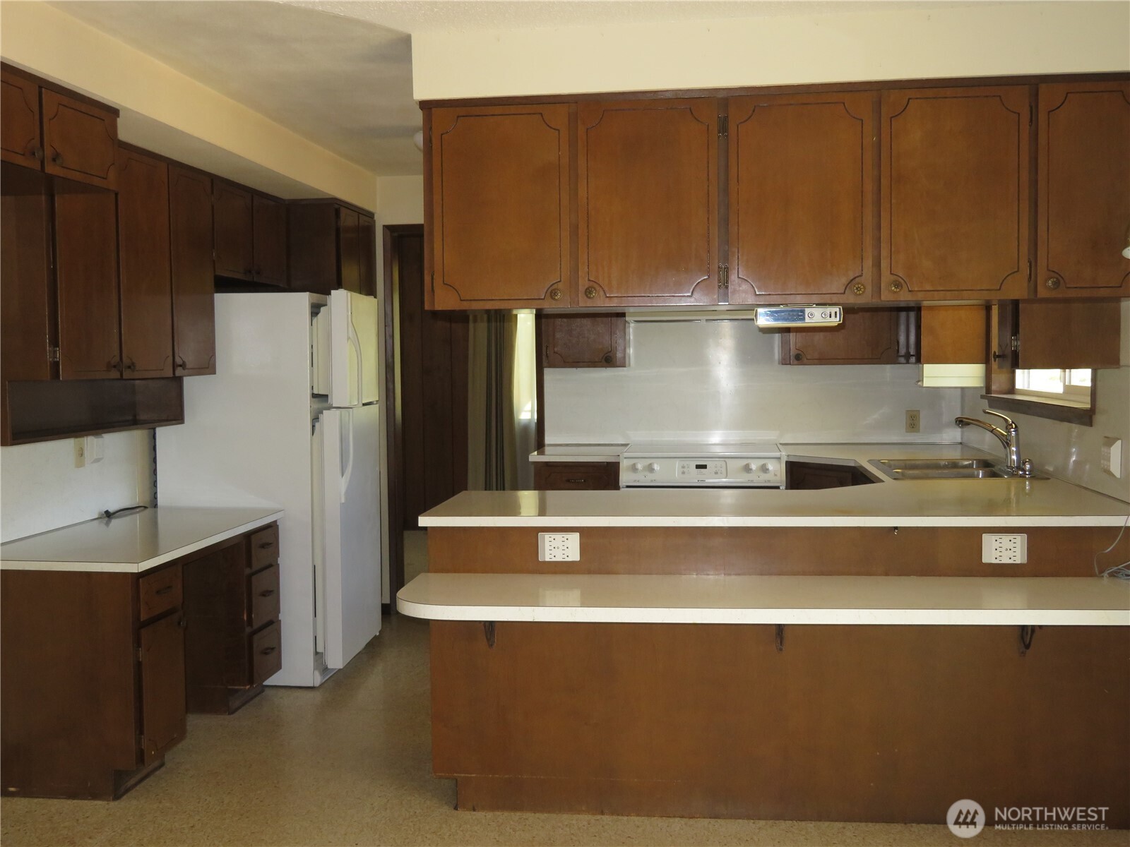 21 Wynoochee Valley Road Montesano, WA 98563 - Photo 22 of 38 a view of a kitchen with a sink and refrigerator
