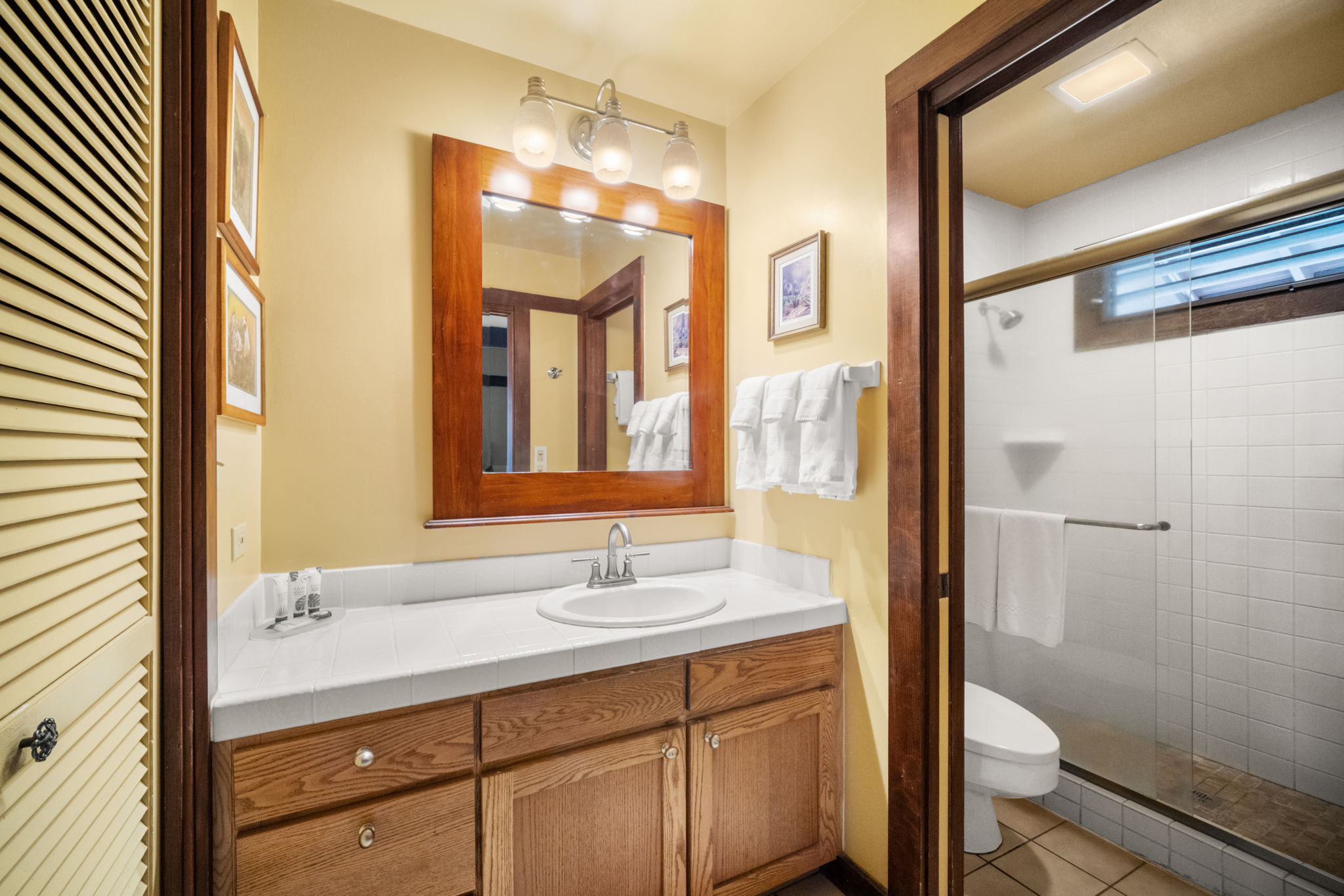 2253 Poipu Road, Unit 25 Koloa, HI 96756 - Photo 12 of 29 a bathroom with a double vanity sink toilet and shower