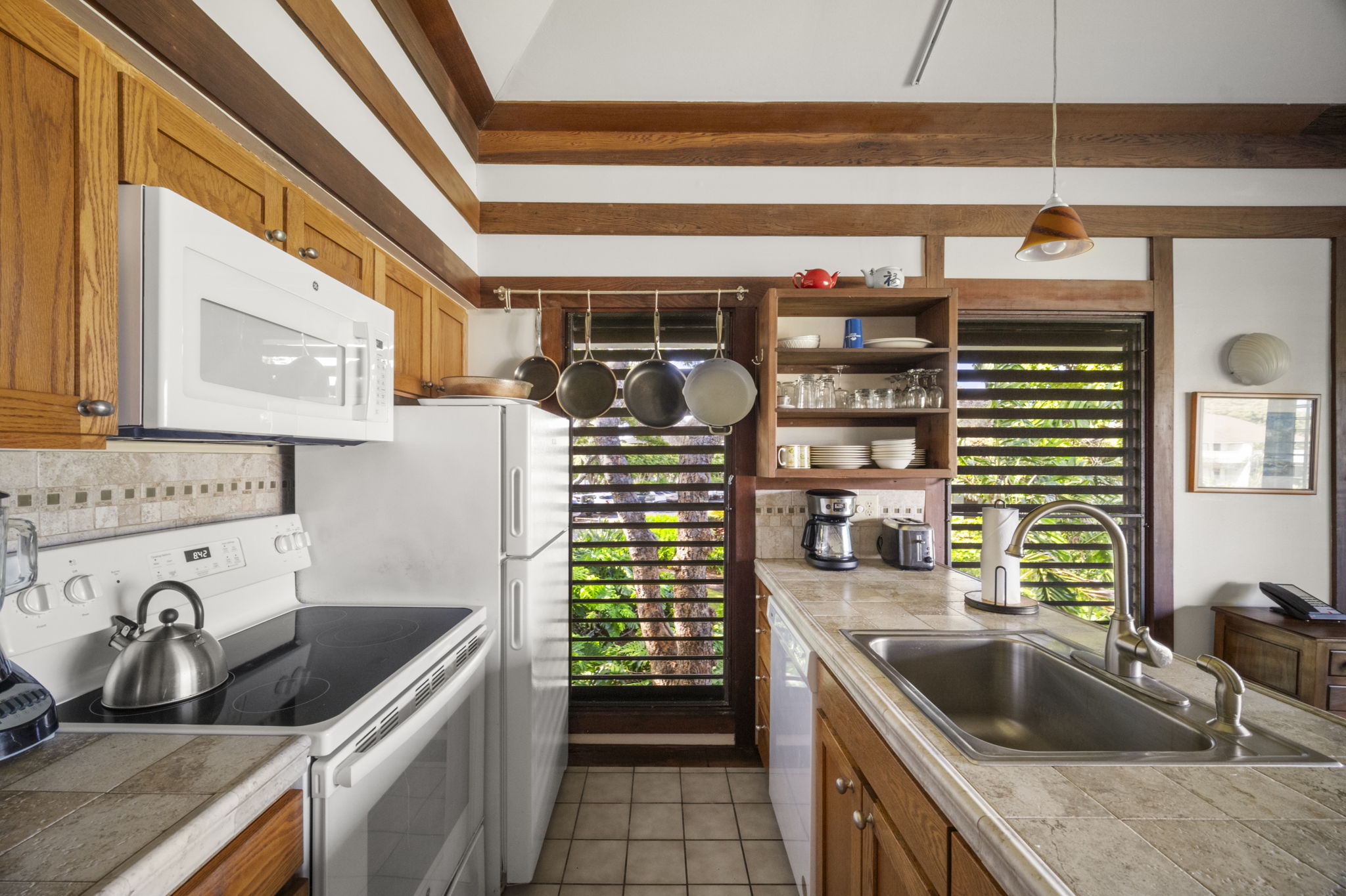 2253 Poipu Road, Unit 25 Koloa, HI 96756 - Photo 8 of 29 a kitchen with a sink stove top oven and cabinets