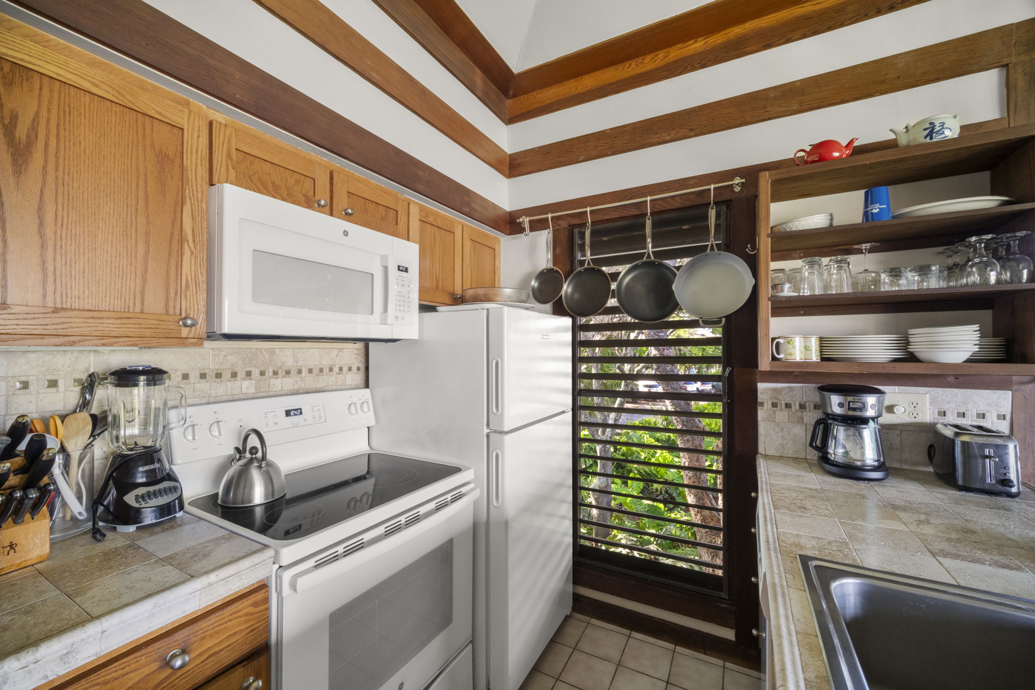 2253 Poipu Road, Unit 25 Koloa, HI 96756 - Photo 9 of 29 a kitchen with a refrigerator and a sink