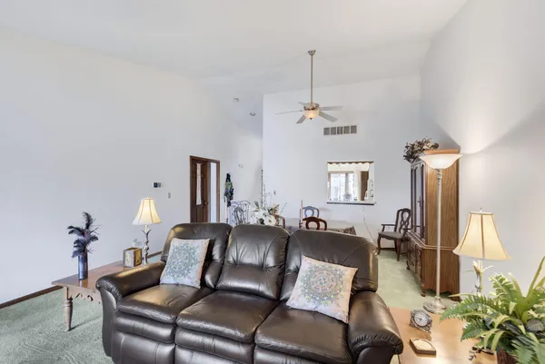 a living room with furniture and a chandelier