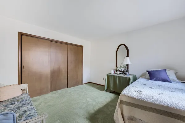 a bedroom with a bed and dresser