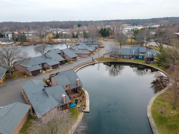 an aerial view of a house with a lake view
