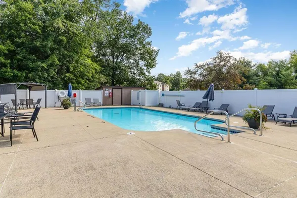 a view of a swimming pool with a lounge chair