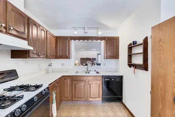 a kitchen with a sink stove and refrigerator