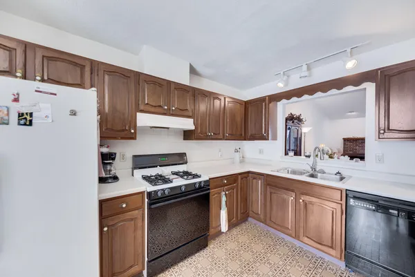 a kitchen with stainless steel appliances a sink stove and cabinets