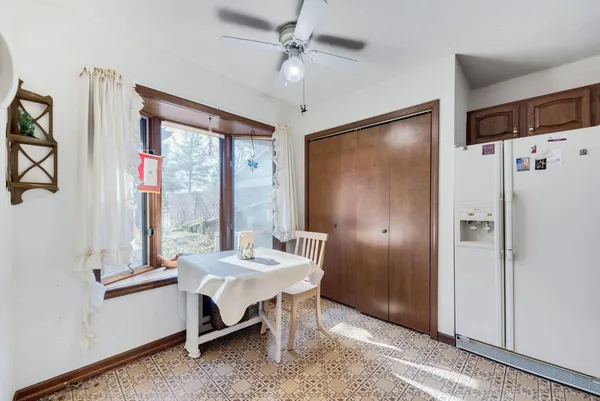 a dining room with furniture a chandelier and a wooden floor