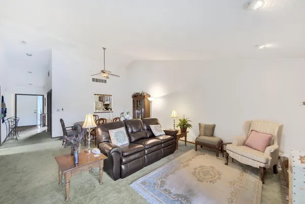 a living room with furniture and a chandelier