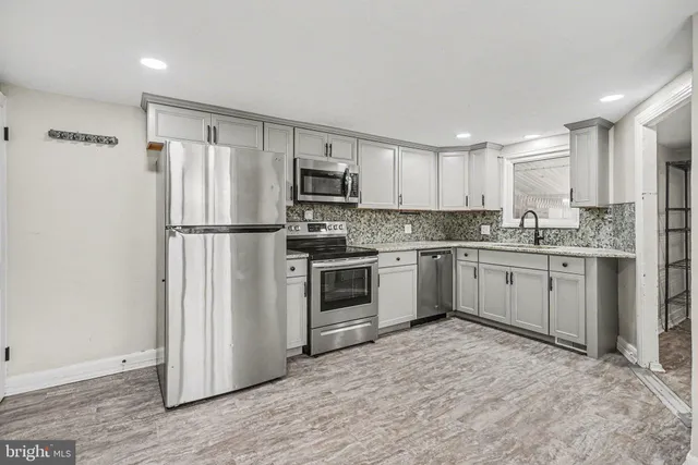 a kitchen with a white cabinets and white appliances