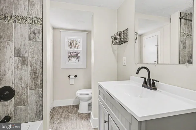 a bathroom with a sink toilet and shower