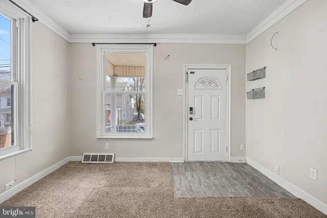 an empty room with windows and closet