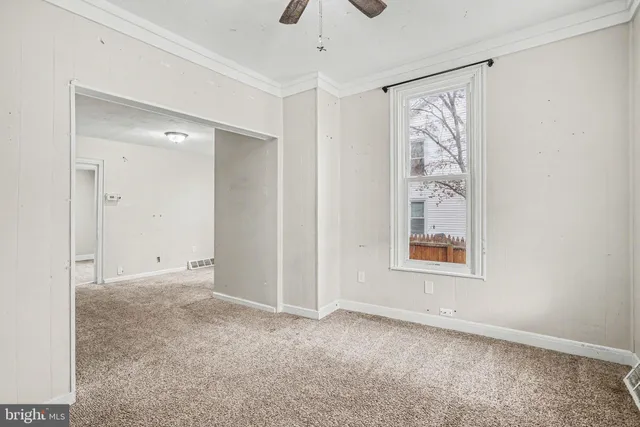 an empty room with windows and closet