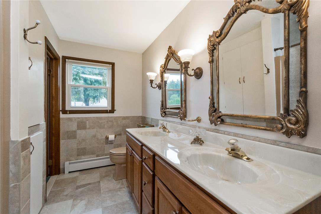 5728 Pheasant Road Bethlehem, PA 18017 - Photo 28 of 39 A spacious double vanity and classic stone tiling define this well-appointed bathroom.