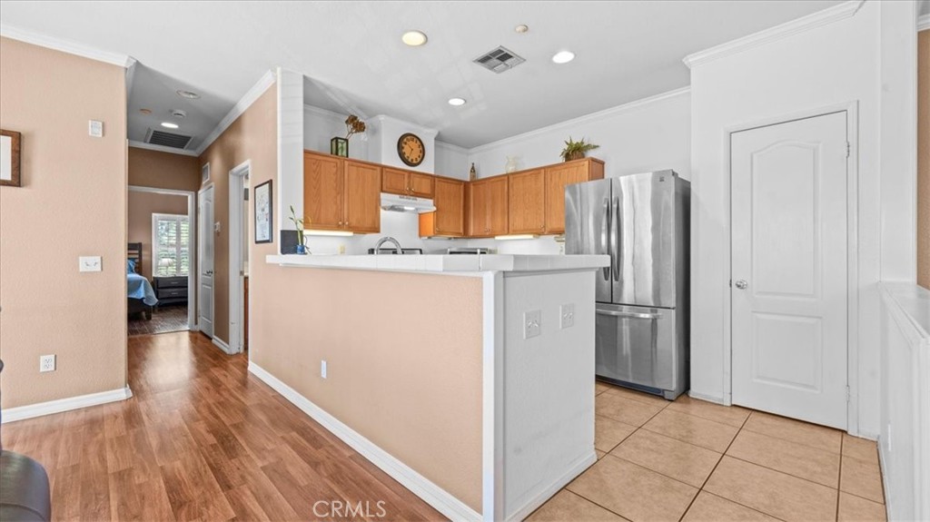 11450 Church Street, Unit 4 Rancho Cucamonga, CA 91730 - Photo 11 of 38 a kitchen with stainless steel appliances a refrigerator and a stove top oven
