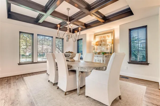 a view of a dining room with furniture wooden floor and chandelier