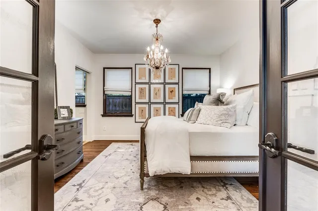 a bedroom with a bed and a chandelier