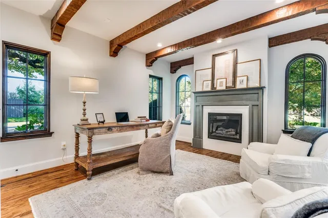 a living room with furniture a window and a fireplace