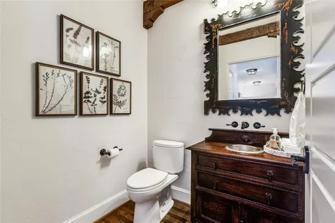 a bathroom with a toilet a sink and a mirror