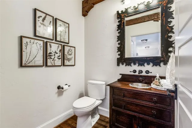 a bathroom with a toilet a sink and a mirror