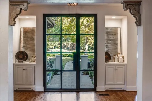 a view of hallway with a large window and wooden floor
