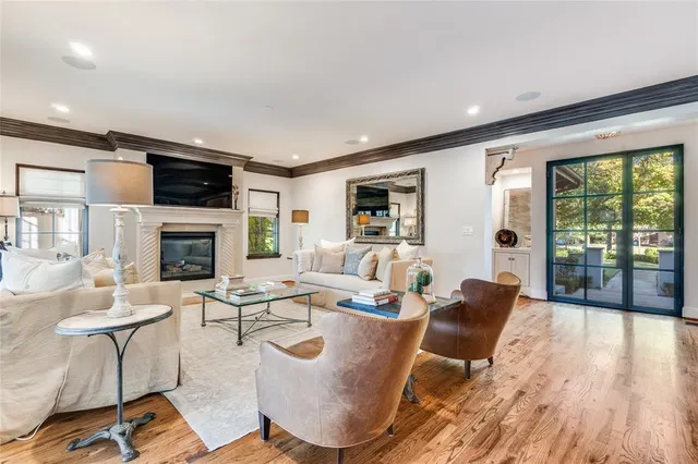 a living room with fireplace furniture and a flat screen tv