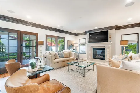 a living room with furniture fireplace and a large window