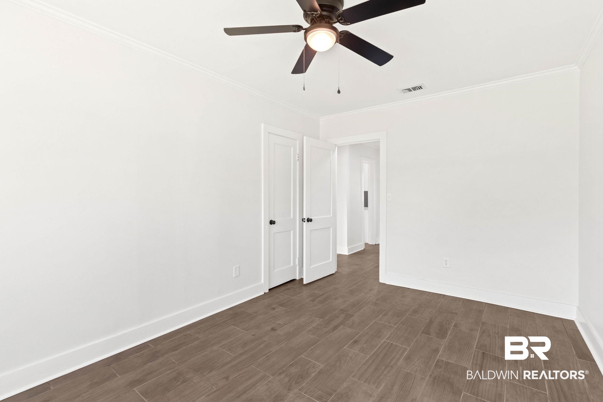 311 Cloverdale Road Atmore, AL 36502 - Photo 37 of 63 Room featuring wood-look tile flooring, white baseboards, and white walls